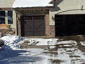 These brown carriage house garage doors are perfect for the snowed in country look