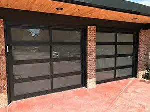 These steel and glass garage doors look stately against the brick facade