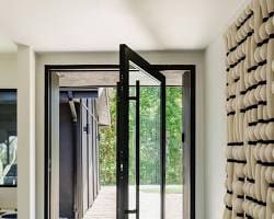 A pivot door rotates on a vertical hinge located on the floor and top of the door frame
