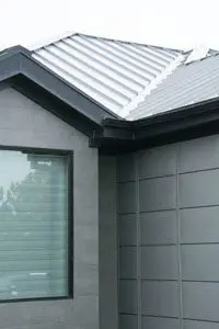 This black gutter system is camouflaged into the standing seam roof